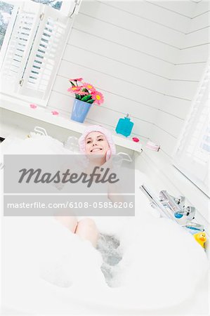 Young smiling woman having a bath
