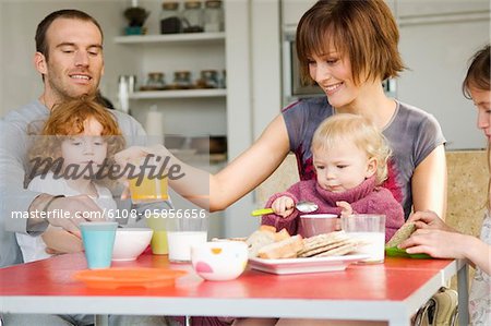 Couple and 3 children at breakfast table