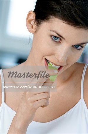 Portrait of a young woman eating apple slice