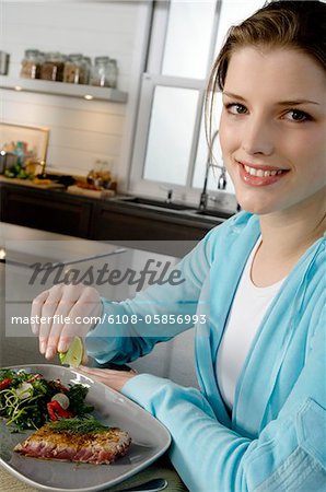Young woman eating meat and vegetables