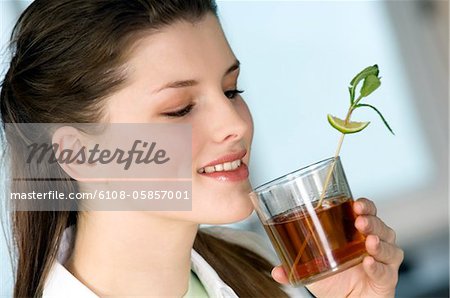 Portrait of a young woman drinking tea