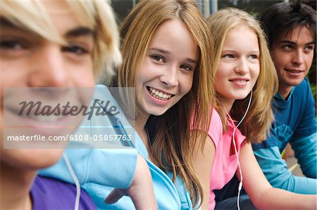 2 teenage boys and 2 teenage girls smiling for camera