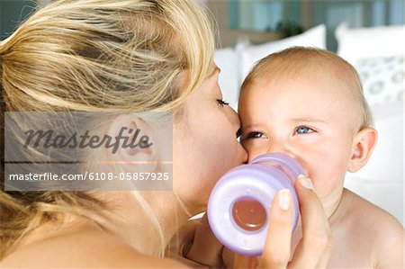 Mother feeding her baby, indoors