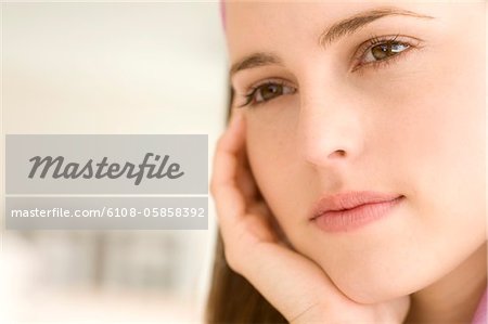 Portrait of a thoughtful young woman, indoors