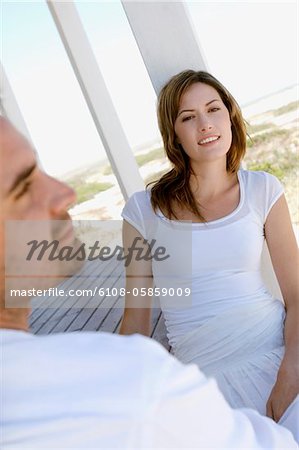 Couple sitting on wooden terrace
