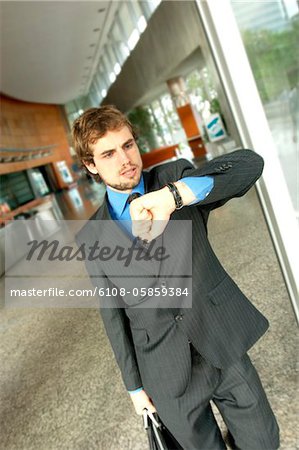 Businessman looking at wristwatch