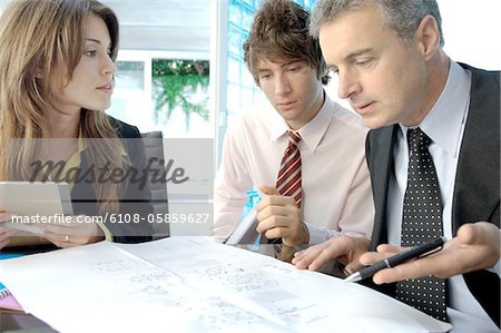 Businessman discussing with colleagues in office