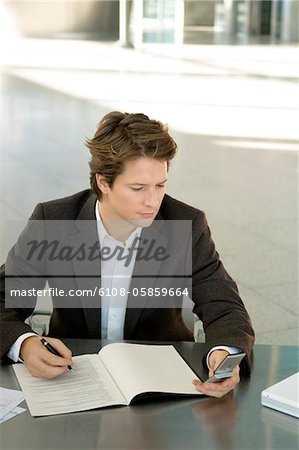 Businessman text messaging with a mobile phone