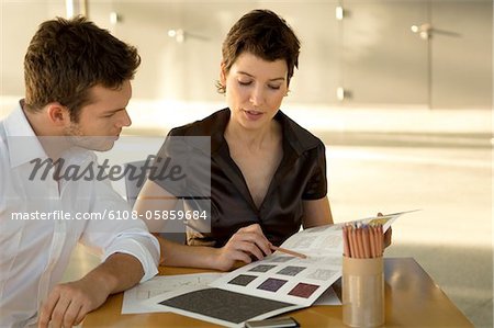 Two interior designers discussing on a color swatch