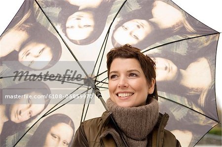 Close-up of a mid adult woman holding an umbrella