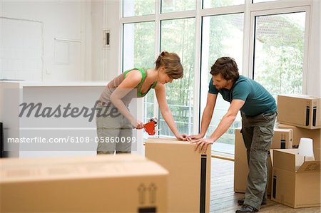 Couple packing cardboard boxes