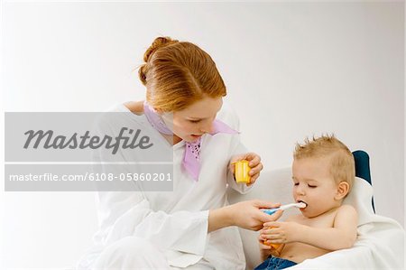 Young woman feeding to her son