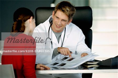 Male doctor explaining a medical record to a female patient