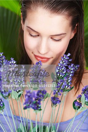 Young woman holding lavender sprigs