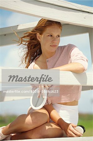 Young woman sitting on a balcony