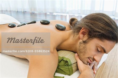 Man receiving hot stone therapy