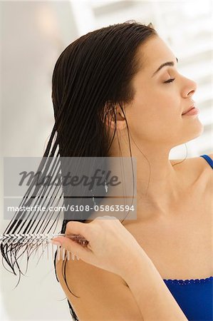 Close-up of a woman combing her hair