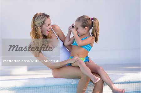 Girl taking a picture of her mother