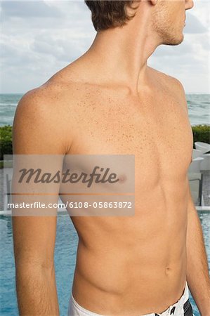 Close-up of a bare chested man on the coast