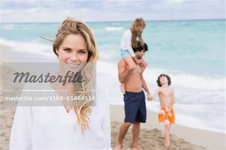 Woman smiling with her family in the background