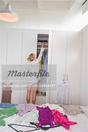 Woman selecting clothes in a wardrobe