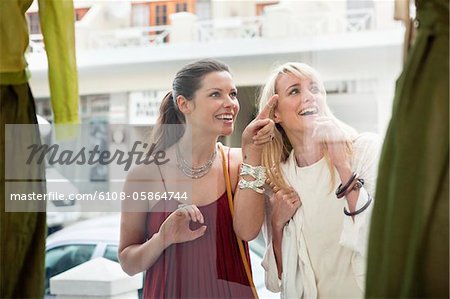 Two women window shopping outside a store
