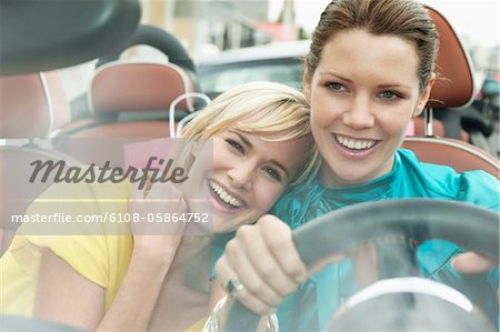 Two women sitting in a car after shopping