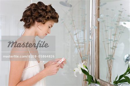 Woman holding contact lens in the bathroom