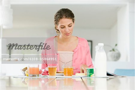 Woman having breakfast at a table