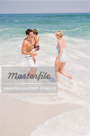 Family playing on the beach