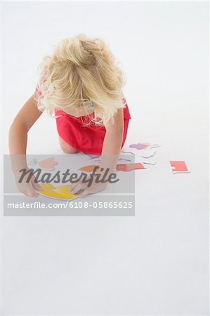 Girl solving a jigsaw puzzle