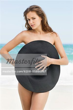 Woman covering her body with a hat