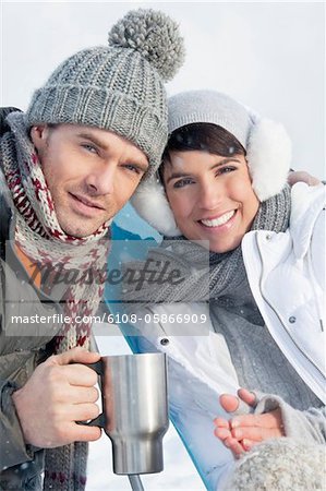 Young couple in ski wear resting