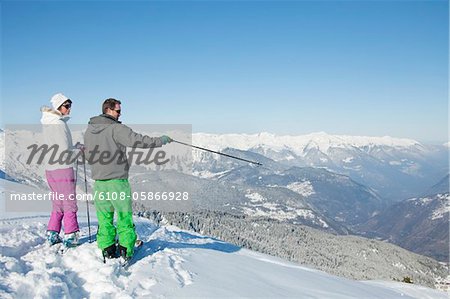 Young couple of skiers on slope