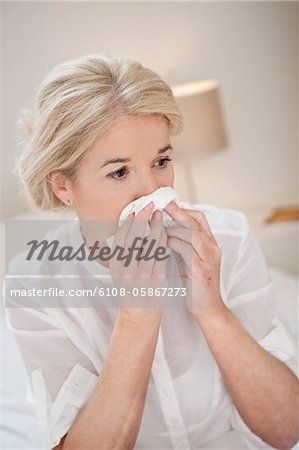 Close-up of a woman suffering from cold