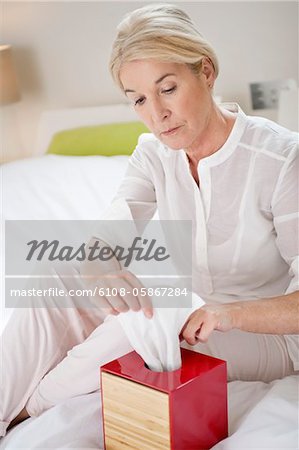 Woman taking out tissue paper from a box