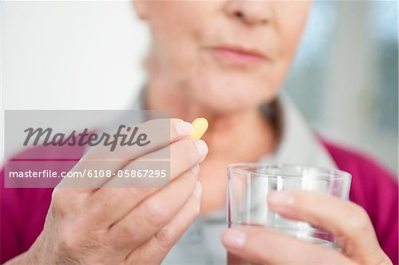Close-up of a woman taking a capsule