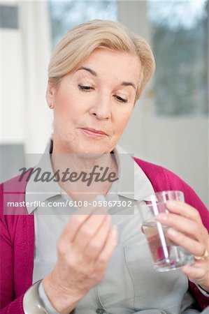 Close-up of a woman taking a capsule