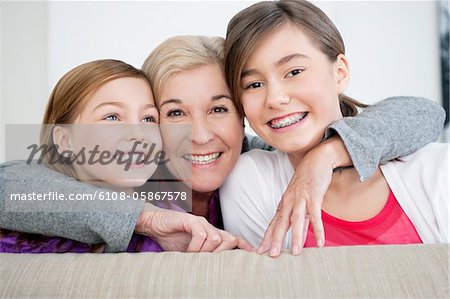Portrait of a woman smiling with her granddaughters