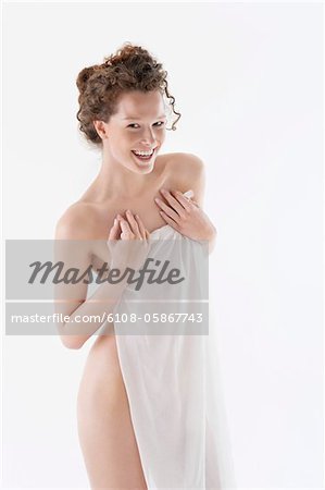 Naked woman covering herself with a sarong