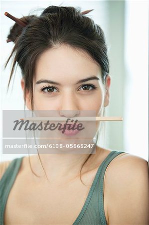 Woman balancing a pencil on lip