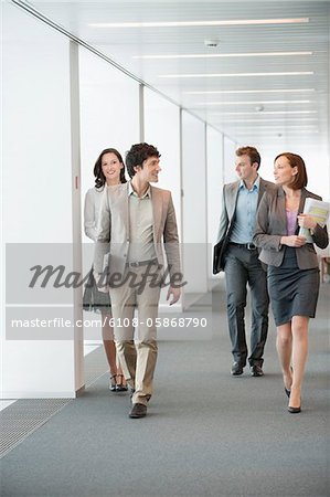 Business executives walking in the corridor of an office