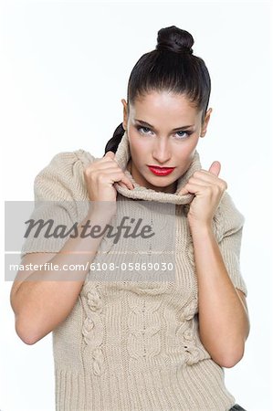 Young woman pulling her turtleneck