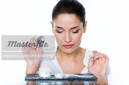 Young woman holding make-up brush