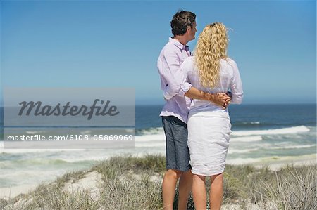 Rear view of a couple looking at sea