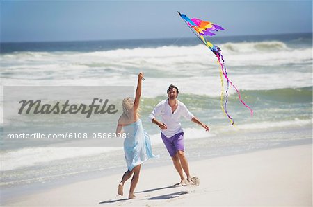 Couple flying kite on the beach