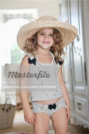 Portrait of a little girl dressed like her mother in oversized accessories  - Stock Photo - Masterfile - Premium Royalty-Free, Code: 6108-05874909