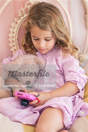 Children playing video game in bed - a Royalty Free Stock Photo