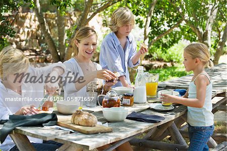 Family having food at front or back yard