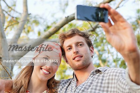Young couple taking a picture of themselves with a mobile phone